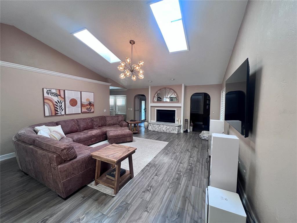 357 Tymber Run Ormond Beach, FL 32174 - Photo 11 of 32 a living room with furniture and a chandelier
