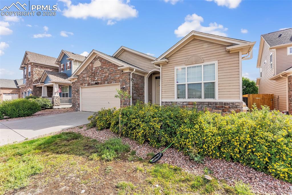 9403 St.George Road Peyton, CO 80831 - Photo 2 of 39 a front view of a house with garden