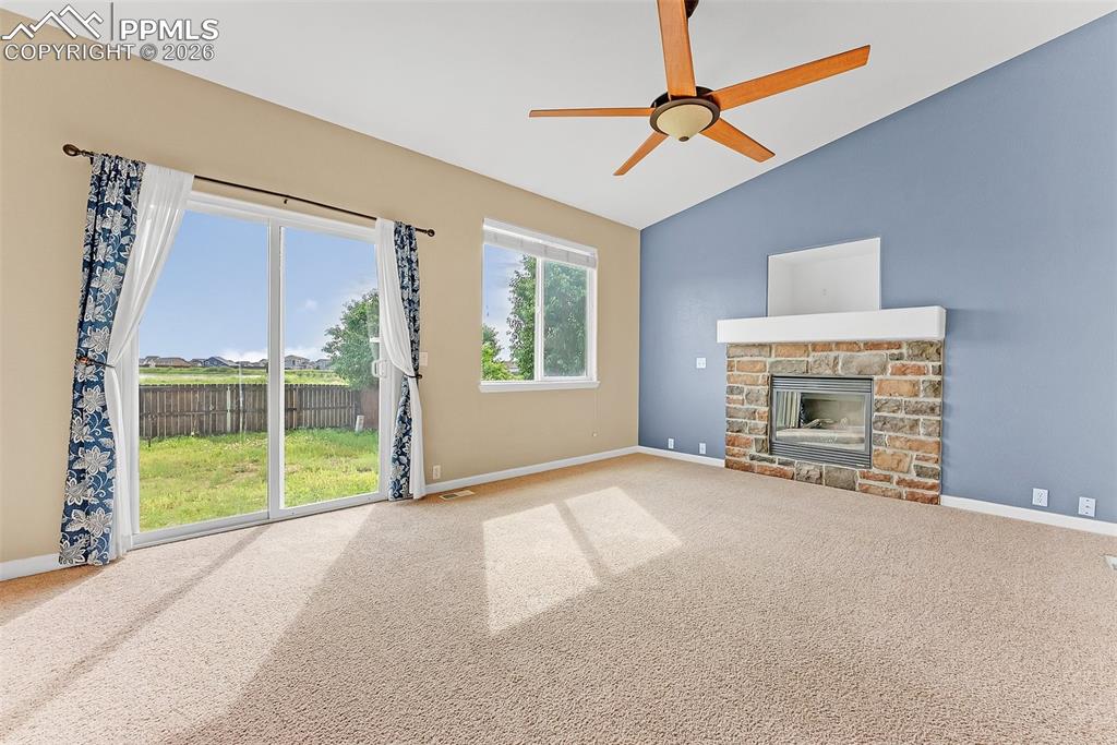 9403 St.George Road Peyton, CO 80831 - Photo 6 of 39 en empty room with windows and fireplace