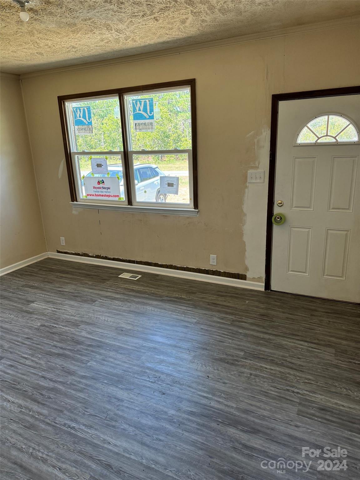 131 Kristy Lane Rockingham, NC 28379 - Photo 14 of 35 an empty room with wooden floor and windows