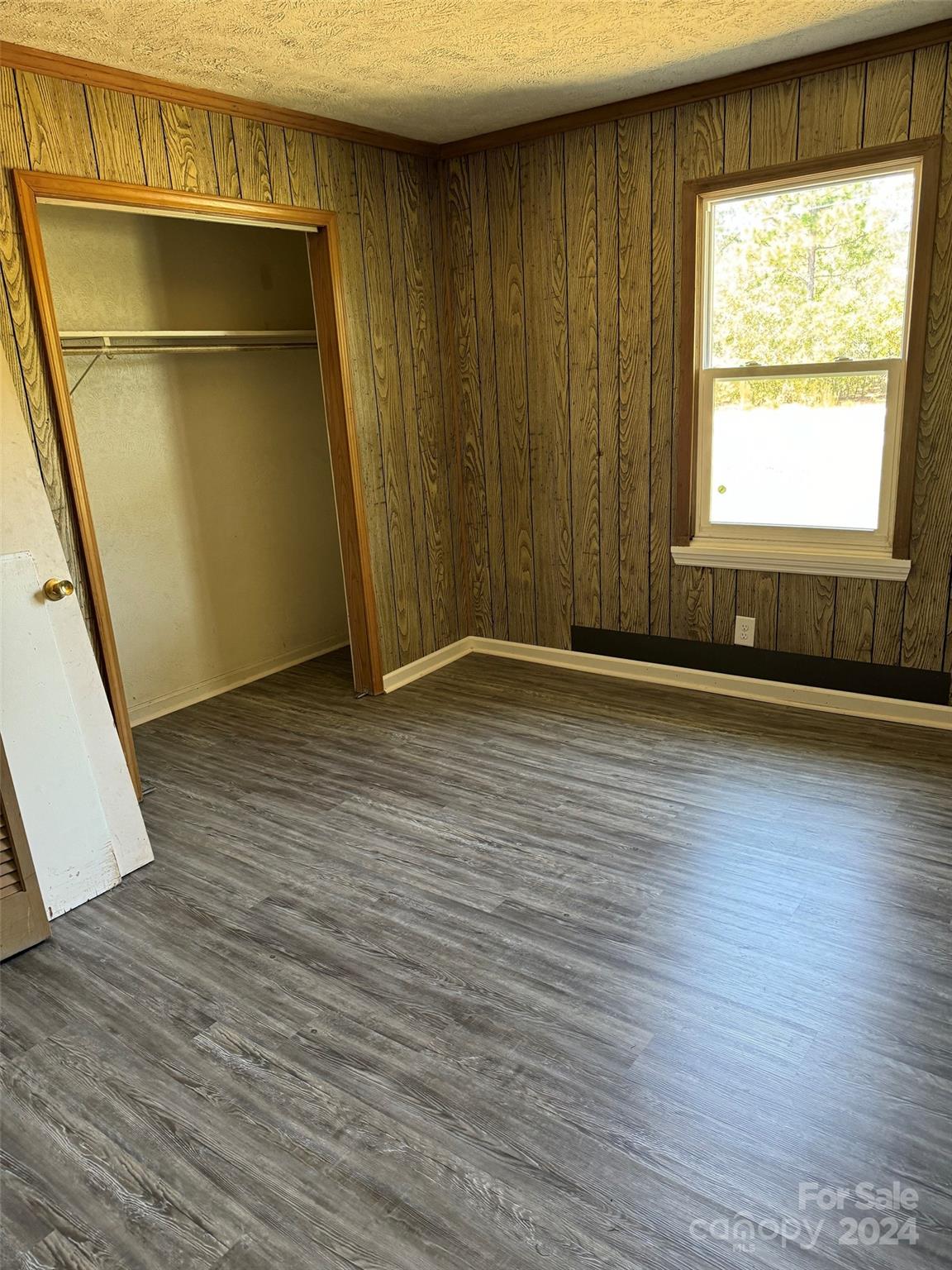 131 Kristy Lane Rockingham, NC 28379 - Photo 26 of 35 an empty room with wooden floor and windows