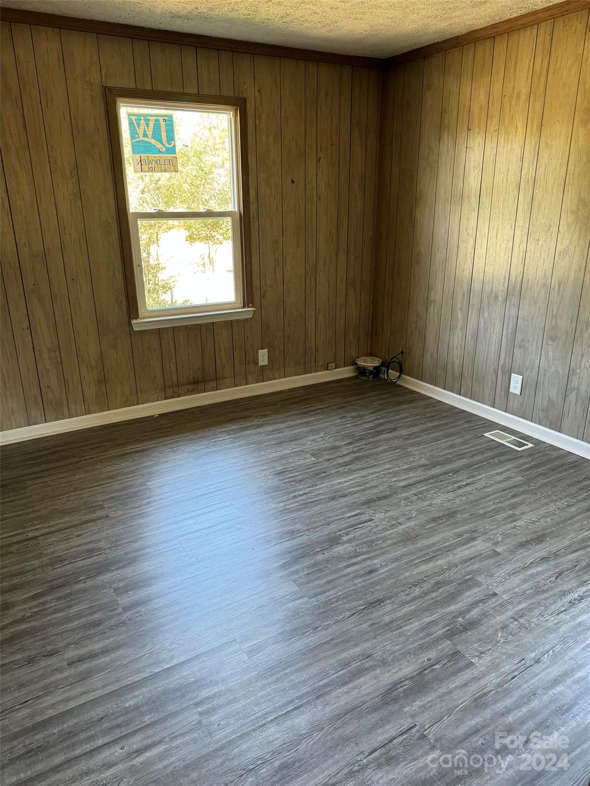 131 Kristy Lane Rockingham, NC 28379 - Photo 28 of 35 an empty room with wooden floor and windows