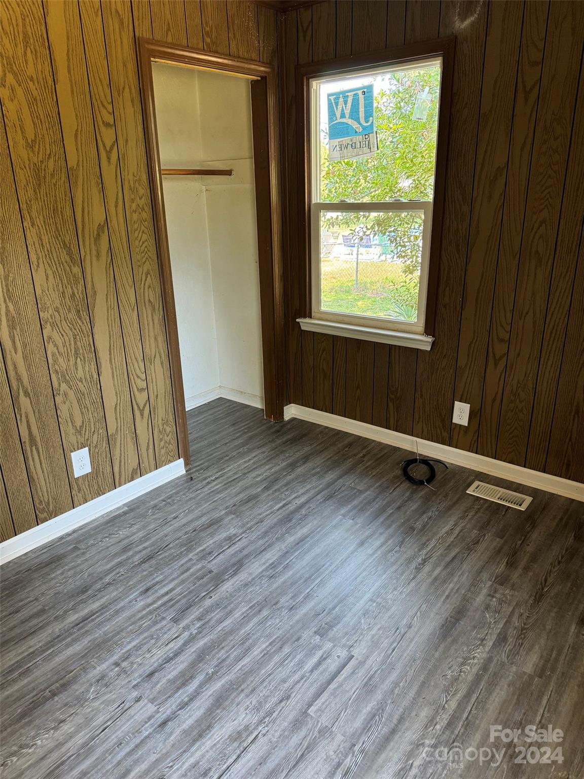 131 Kristy Lane Rockingham, NC 28379 - Photo 31 of 35 a view of an empty room with wooden floor and a window