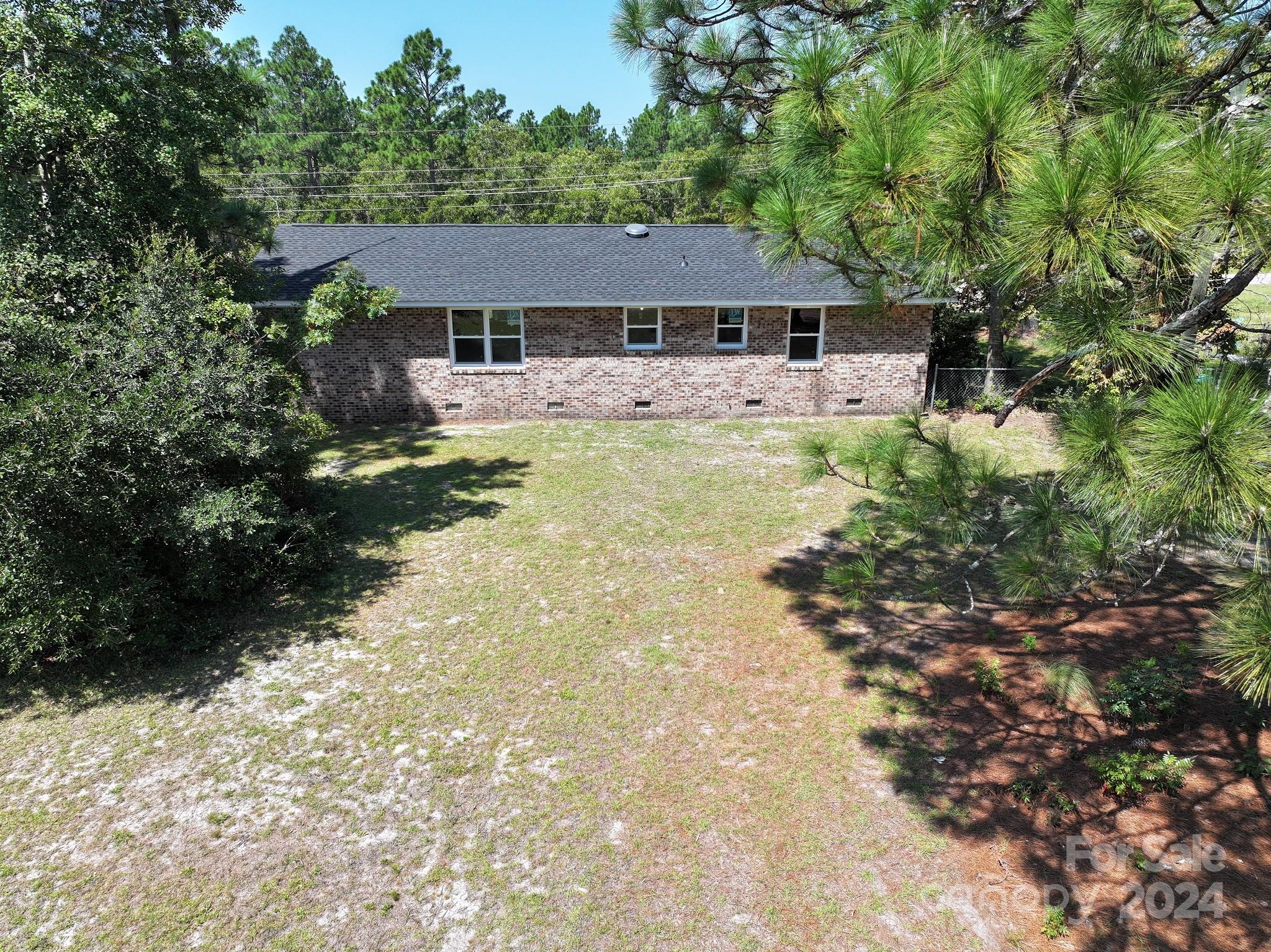 131 Kristy Lane Rockingham, NC 28379 - Photo 8 of 35 a view of a white house with a large pool and large trees