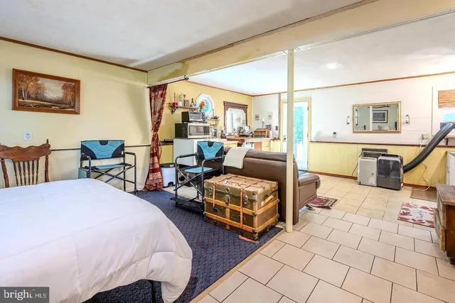 a bedroom with furniture and a large window