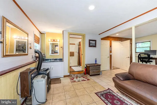 a living room with furniture gym equipment and large windows