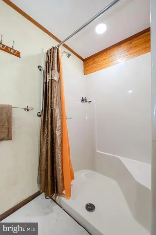 a bathroom with a tub and a shower