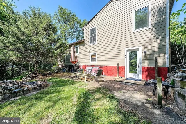 a view of a house with backyard and sitting area