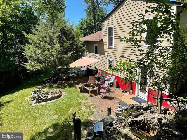 a view of a chairs and table in backyard