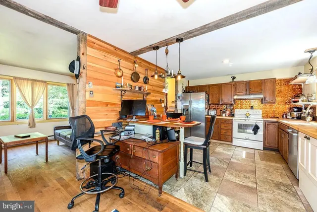 a living room with furniture kitchen view and large windows
