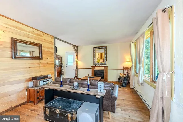 a dining room with wooden floor and furniture