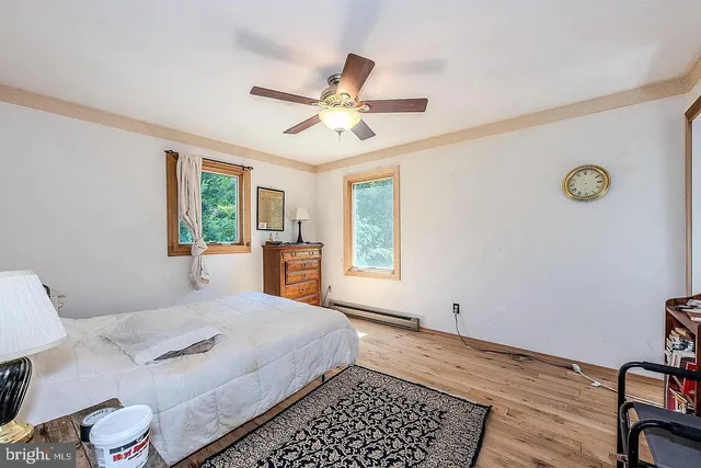 a bedroom with a bed and a window