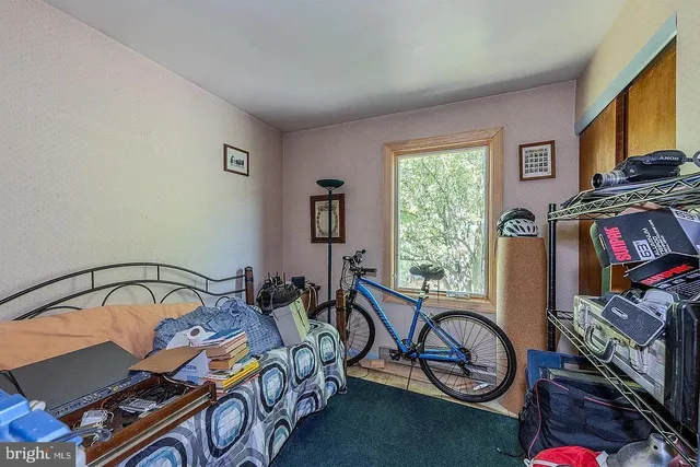 a bedroom with furniture and a window