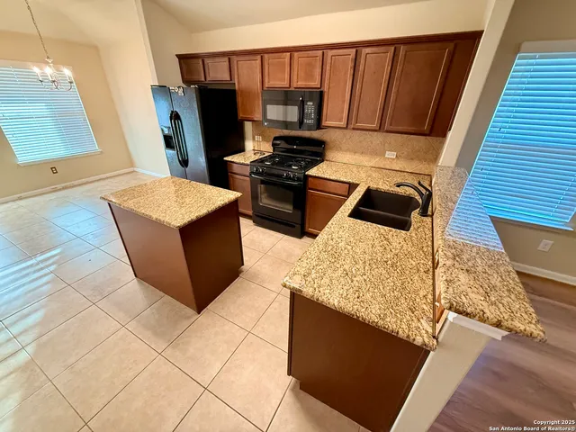 a stove top oven sitting inside of a kitchen