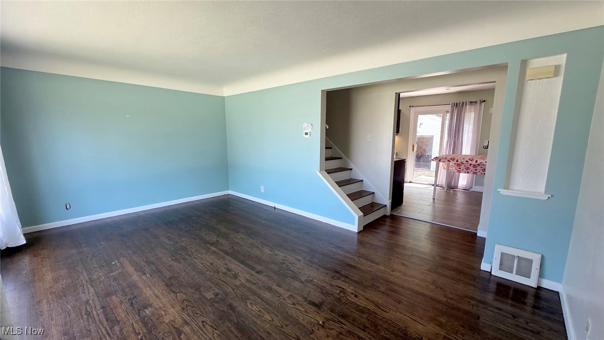 30616 Clarmont Road Willowick, OH 44095 - Photo 11 of 17 Unfurnished room featuring stairs and dark wood finished floors