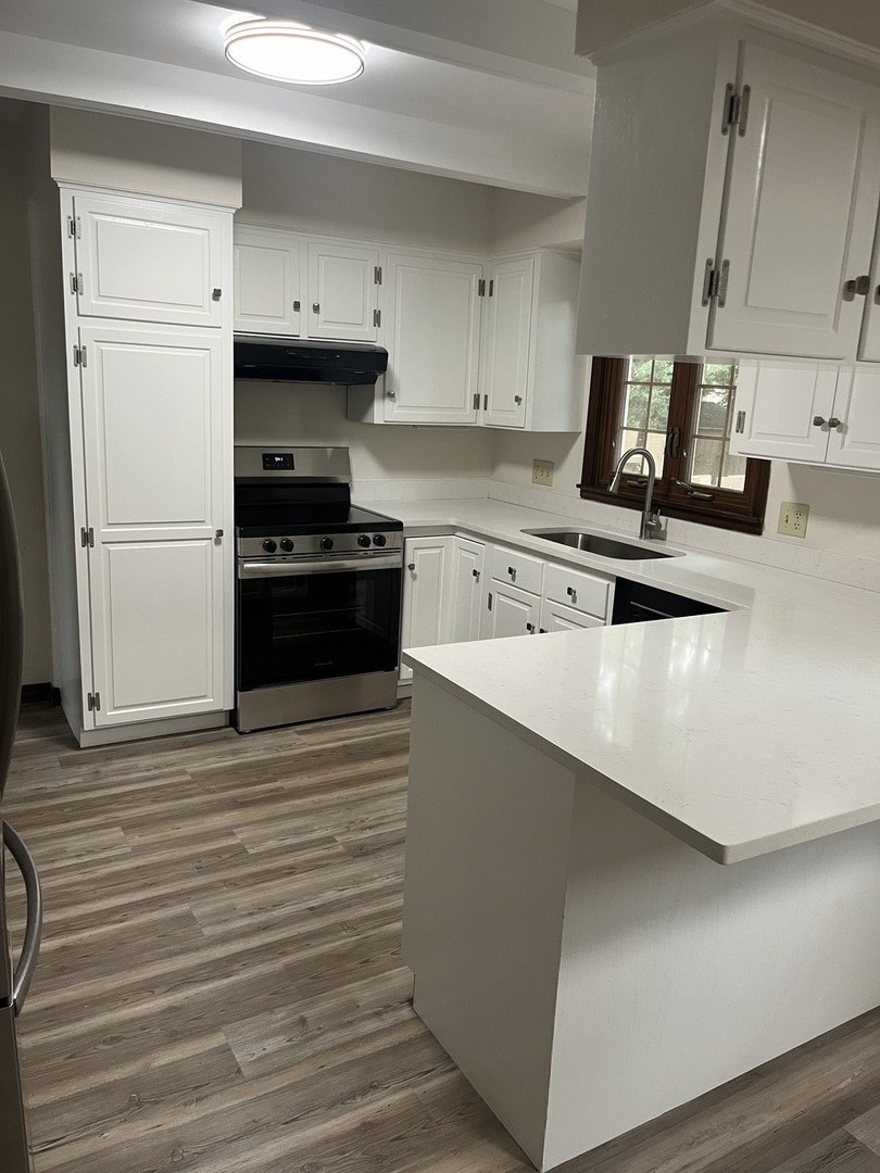 1019 Gregory Street Normal, IL 61761 - Photo 11 of 60 a kitchen with stainless steel appliances a stove a sink and white cabinets