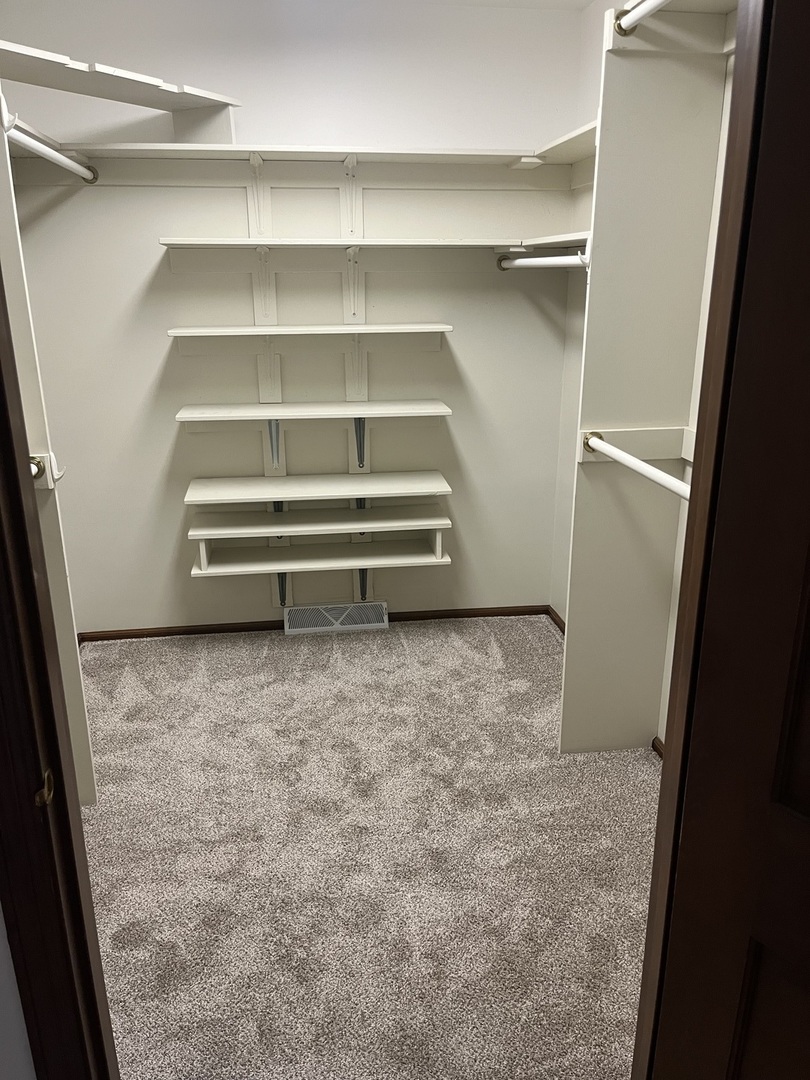 1019 Gregory Street Normal, IL 61761 - Photo 25 of 60 a view of walk in closet with empty racks