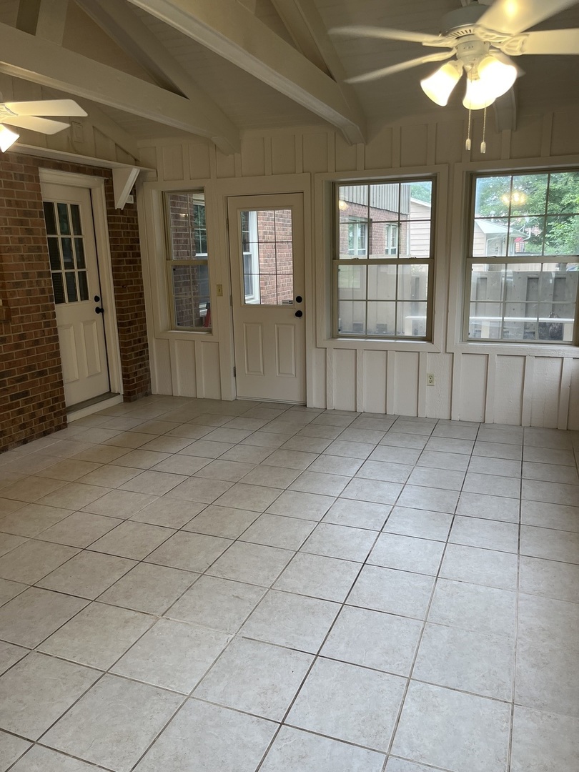 1019 Gregory Street Normal, IL 61761 - Photo 52 of 60 an empty room with chandelier fan and windows