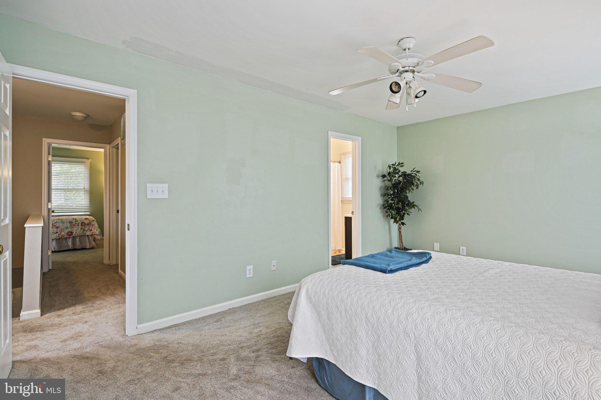1617 Midland Road Edgewater, MD 21037 - Photo 18 of 41 a bedroom with a large bed and chandelier