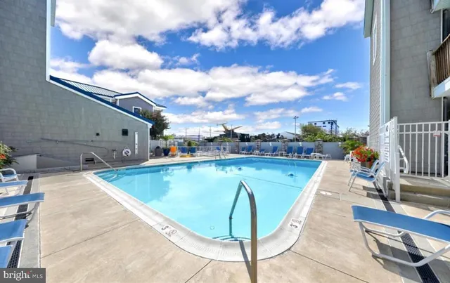 a view of a swimming pool with seating space