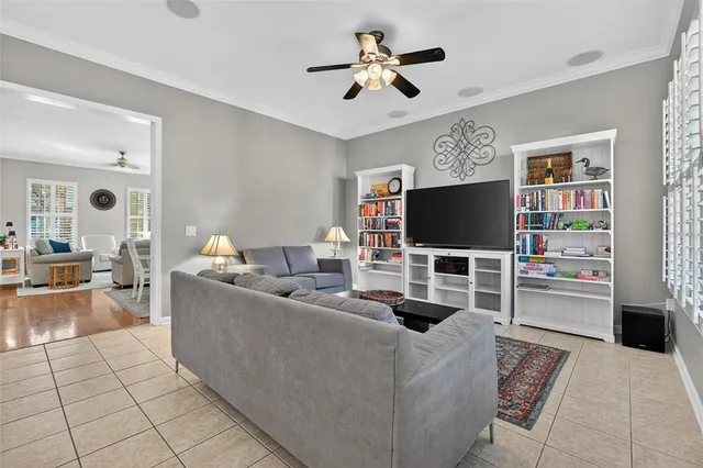 a living room with furniture kitchen view and a chandelier