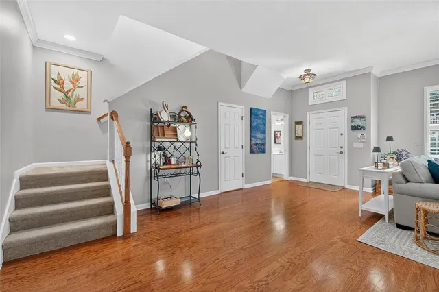 a living room with furniture dining table and a wooden floor
