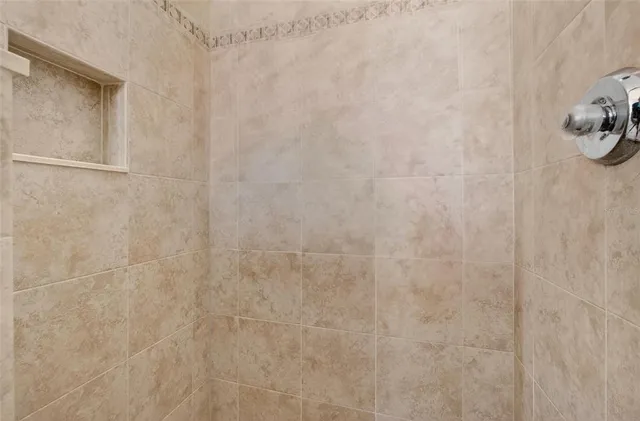 a bedroom with a bed a dresser and a large window