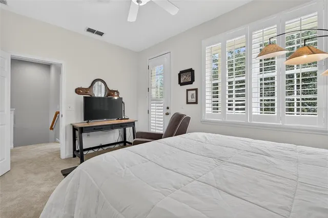 a bed room with a bed and a chair