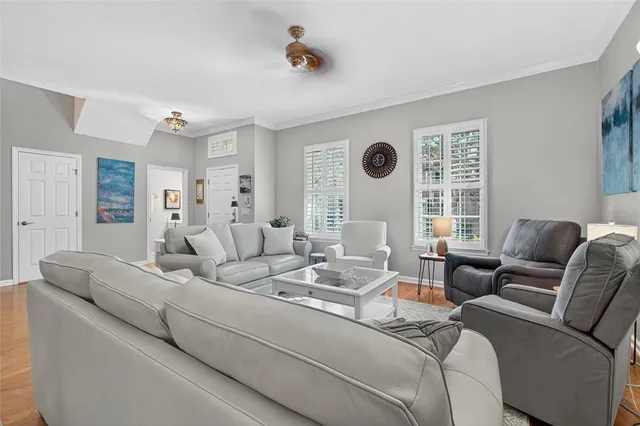 a living room with furniture and a chandelier