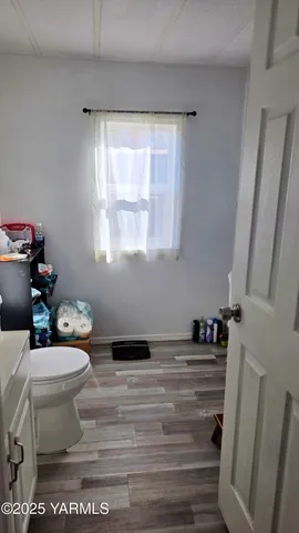 a white toilet sitting next to a window