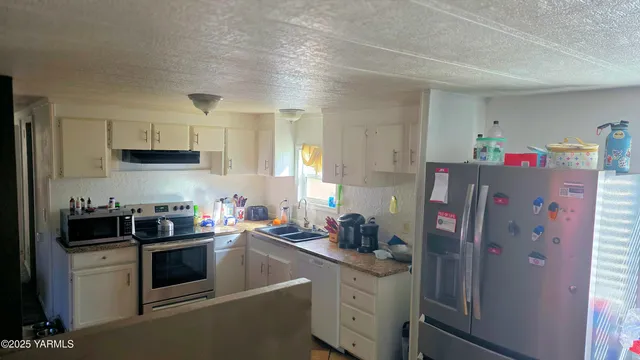 a kitchen with refrigerator and cabinets