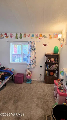 a bedroom with furniture and a wooden floor
