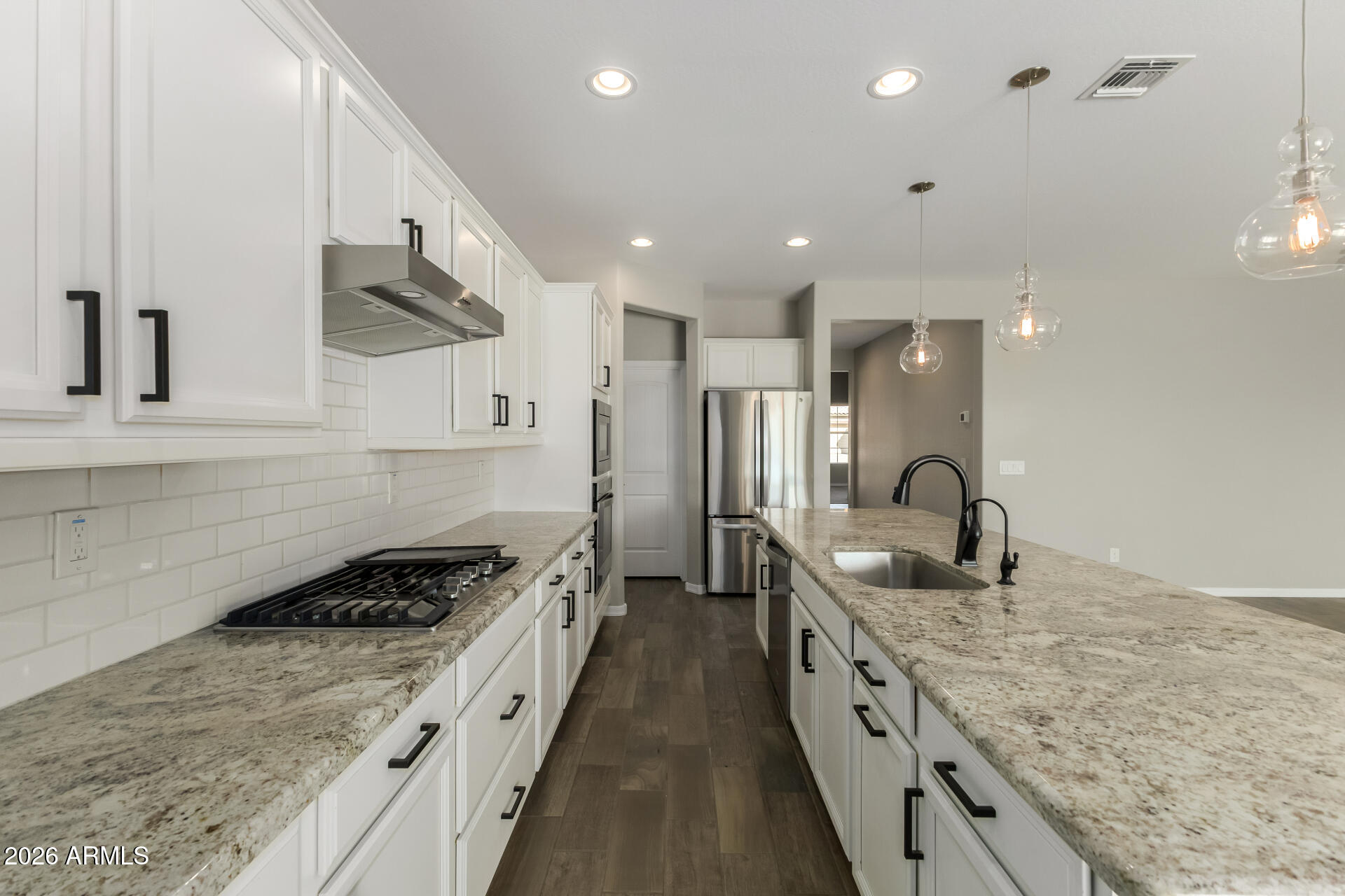 17771 West Granite View Drive Goodyear, AZ 85338 - Photo 15 of 35 a kitchen with stainless steel appliances granite countertop a sink stove and refrigerator