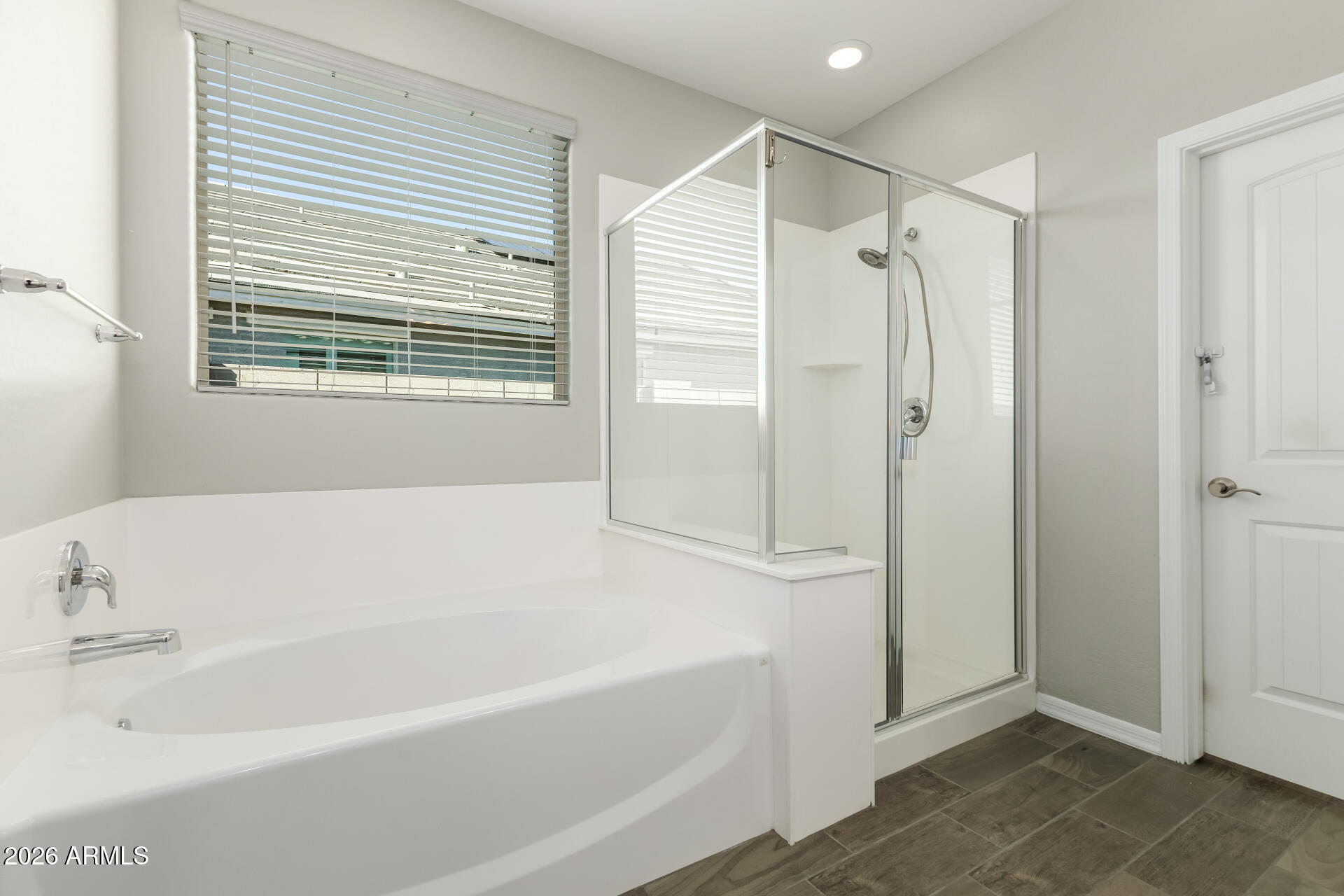 17771 West Granite View Drive Goodyear, AZ 85338 - Photo 20 of 35 a bathroom with a bathtub and a shower