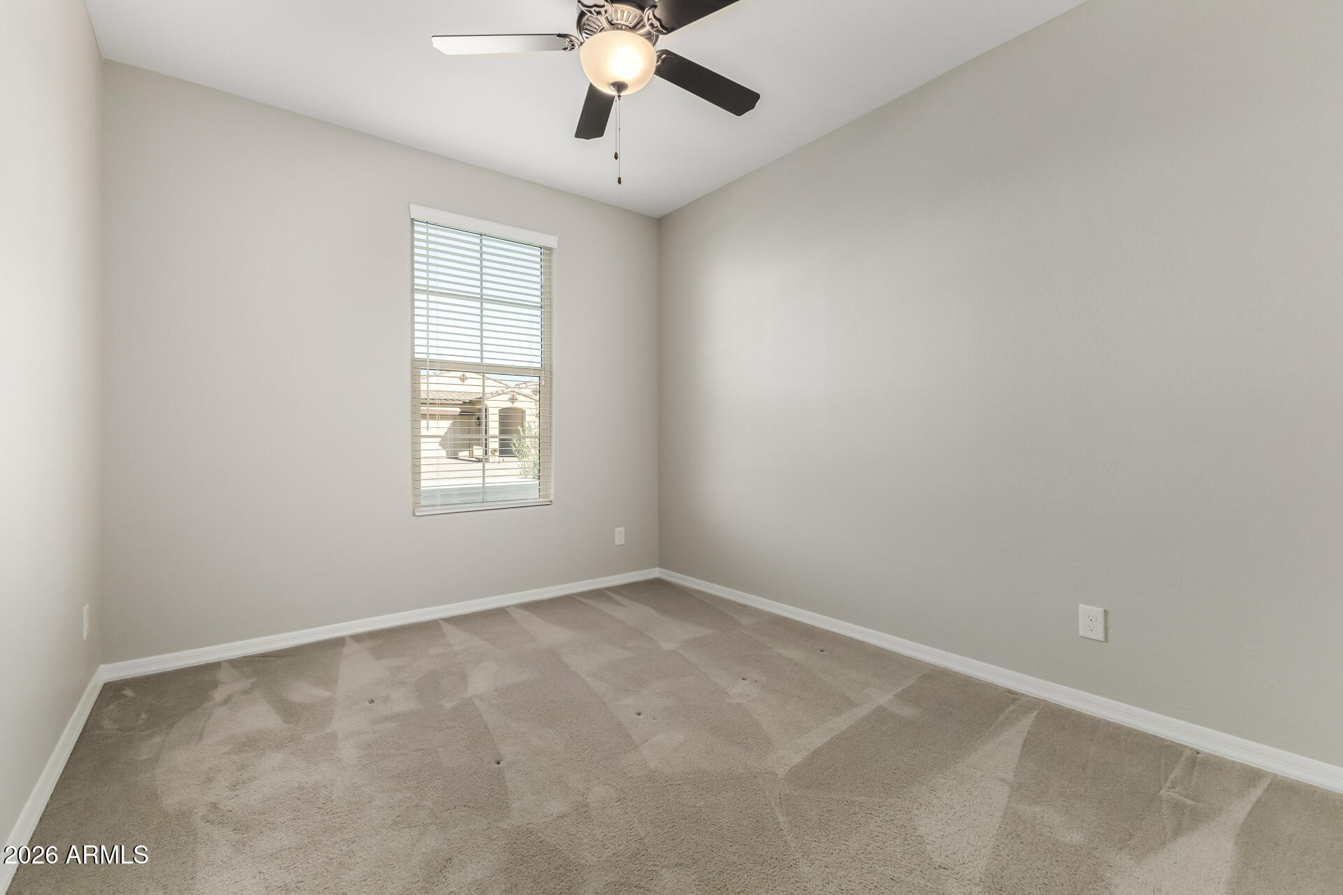 17771 West Granite View Drive Goodyear, AZ 85338 - Photo 23 of 35 an empty room with a window and a ceiling fan