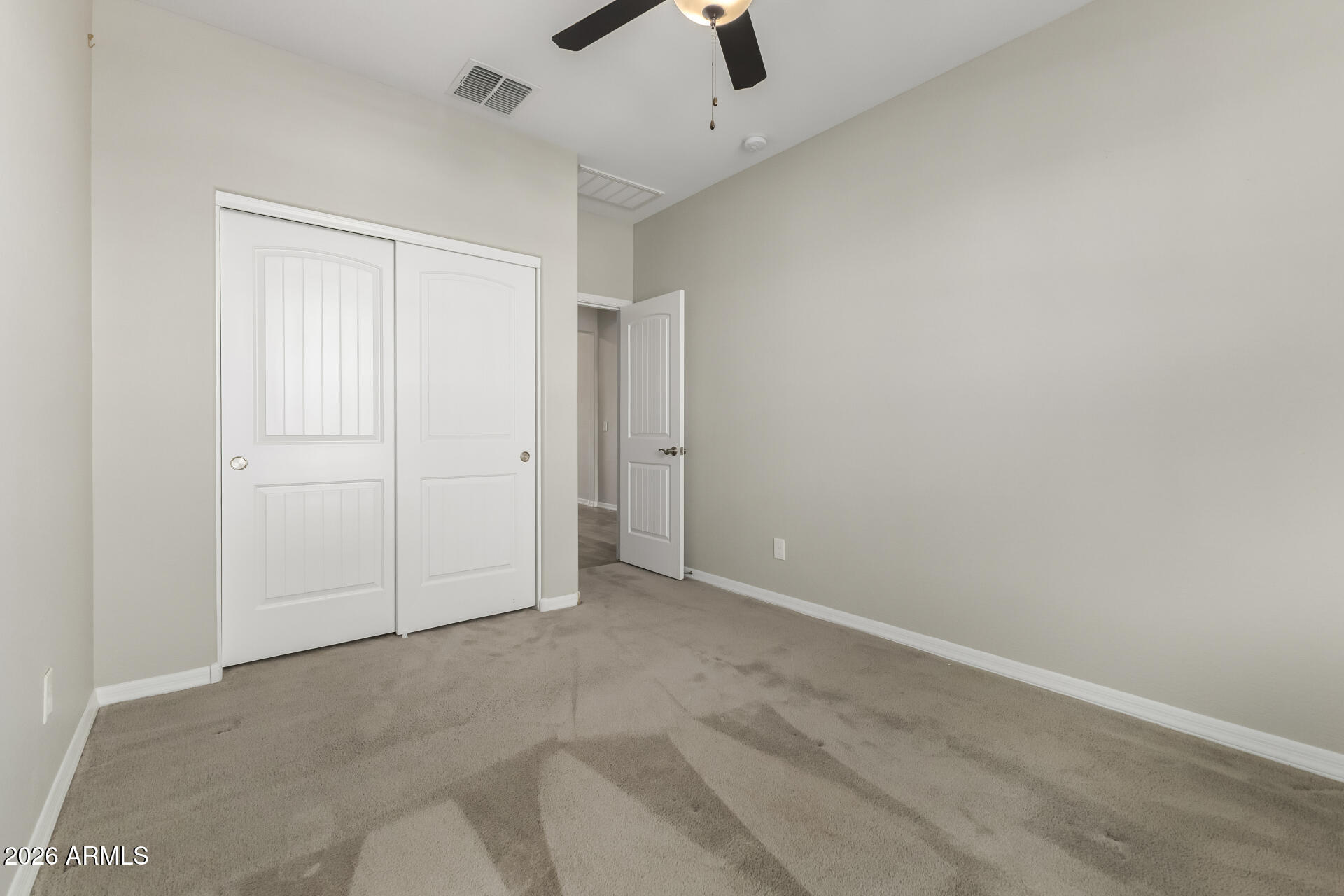 17771 West Granite View Drive Goodyear, AZ 85338 - Photo 24 of 35 an empty room with closet and a chandelier fan