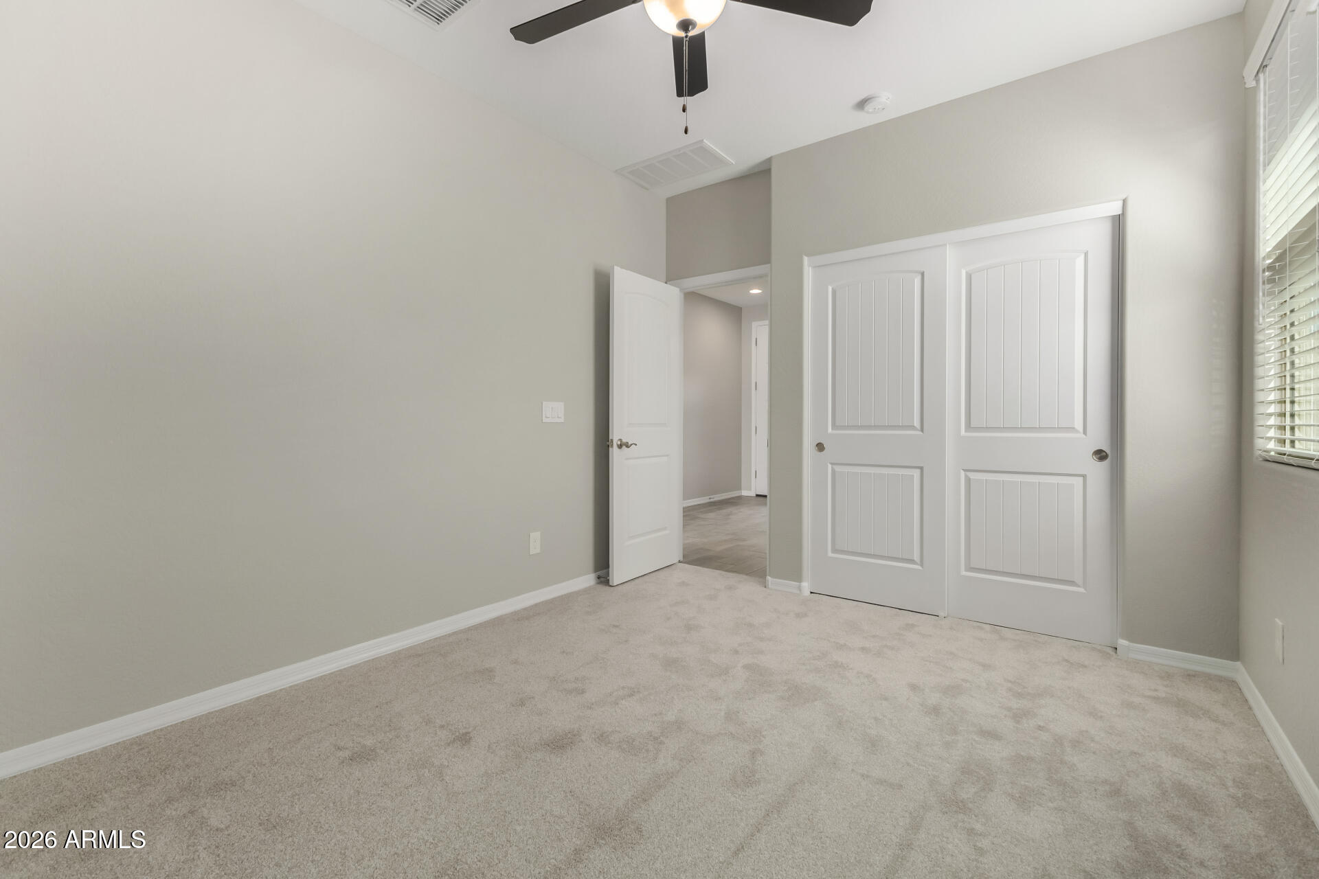 17771 West Granite View Drive Goodyear, AZ 85338 - Photo 26 of 35 an empty room with hallway closet and chandelier fan