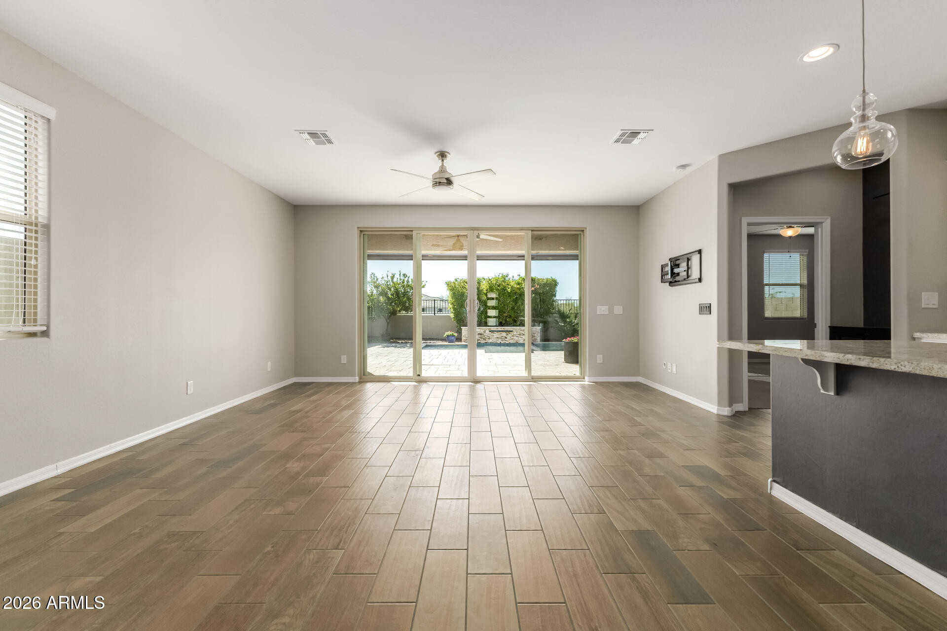 17771 West Granite View Drive Goodyear, AZ 85338 - Photo 8 of 35 wooden floor in an empty room with a window