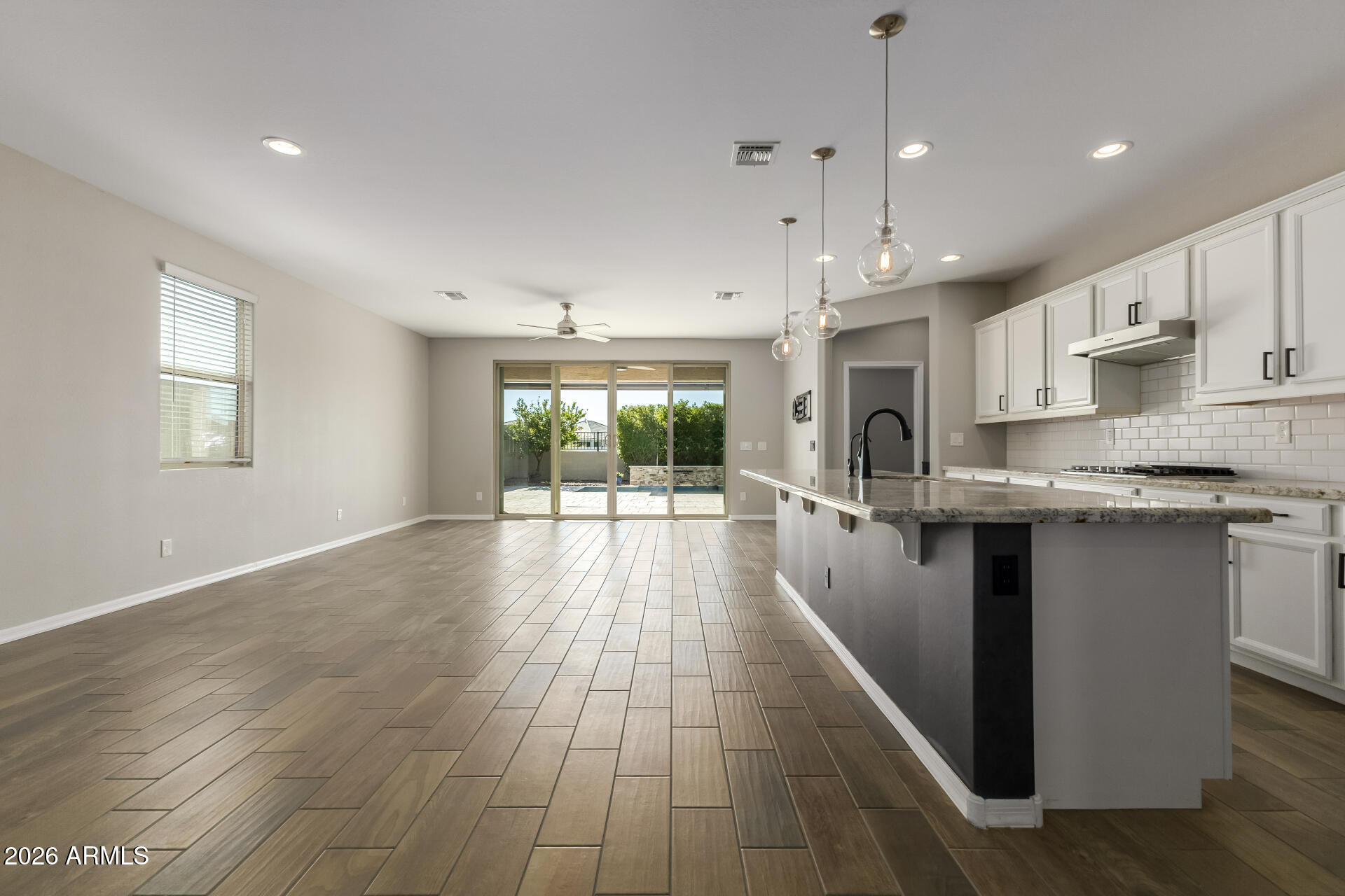 17771 West Granite View Drive Goodyear, AZ 85338 - Photo 9 of 35 a large kitchen with granite countertop a large counter top a sink stainless steel appliances and cabinets