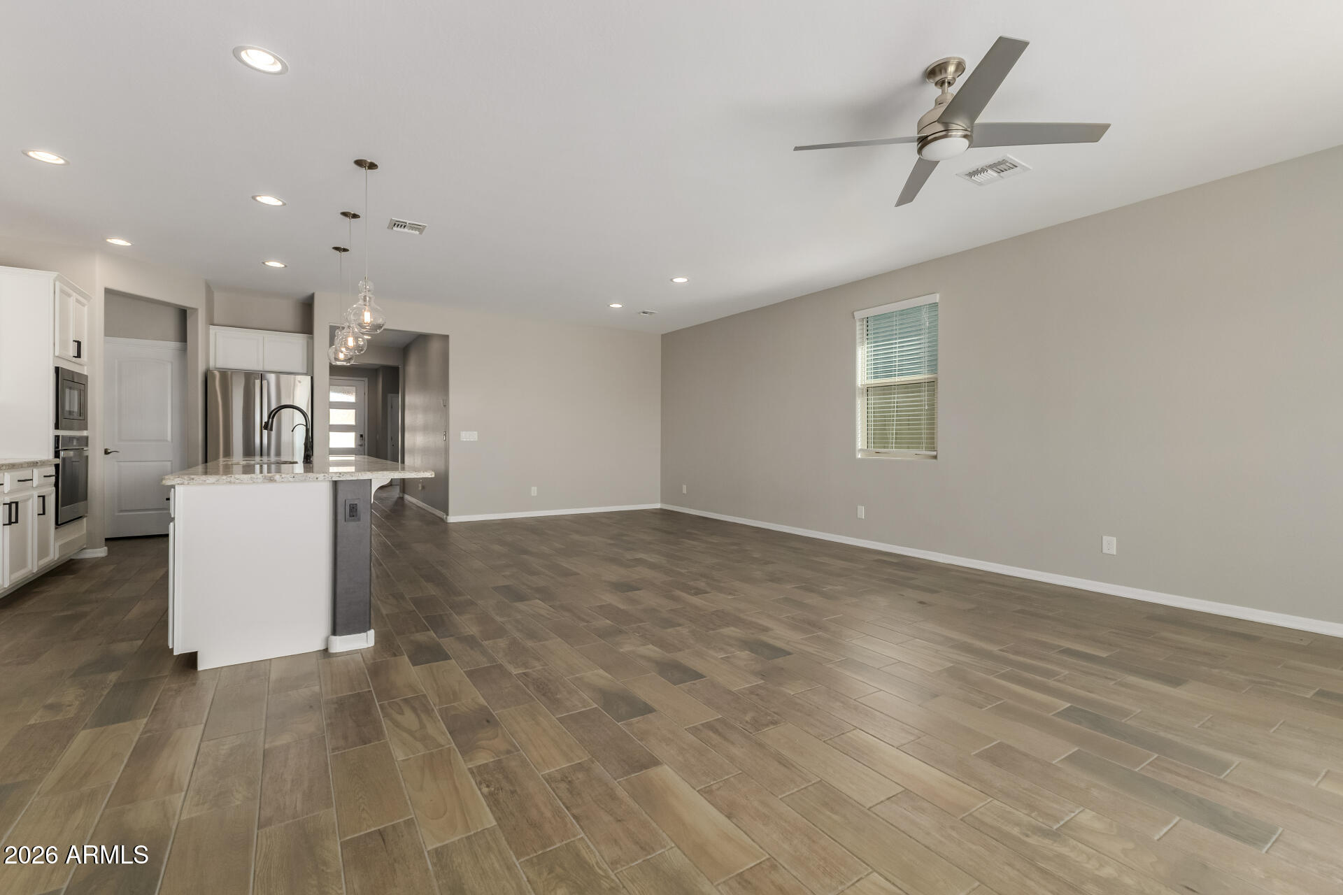 17771 West Granite View Drive Goodyear, AZ 85338 - Photo 10 of 35 a view of a kitchen with furniture and a ceiling fan