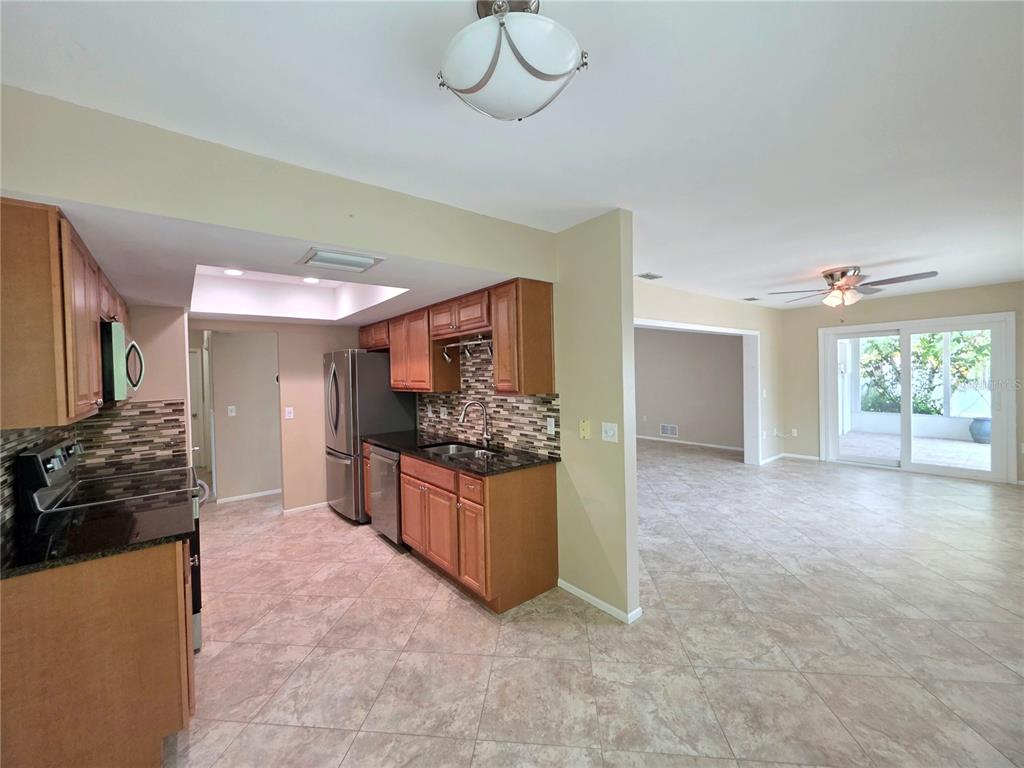 352 Pine Tree Road Venice, FL 34293 - Photo 10 of 25 a large kitchen with a stove and a refrigerator