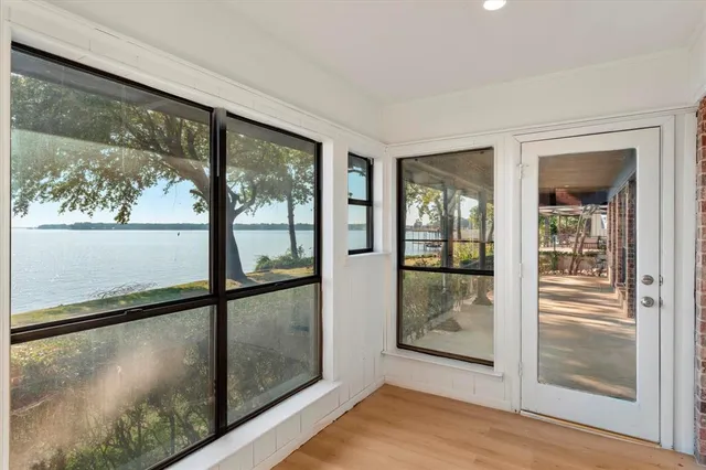 a kitchen with stainless steel appliances a sink dishwasher a stove and white cabinets with wooden floor