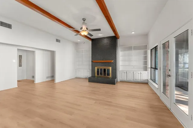 a view of an empty room with a fireplace
