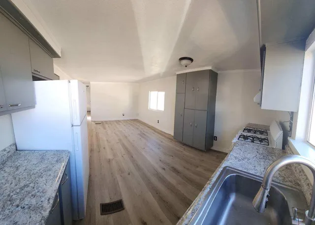 a kitchen with stainless steel appliances a refrigerator and a stove top oven