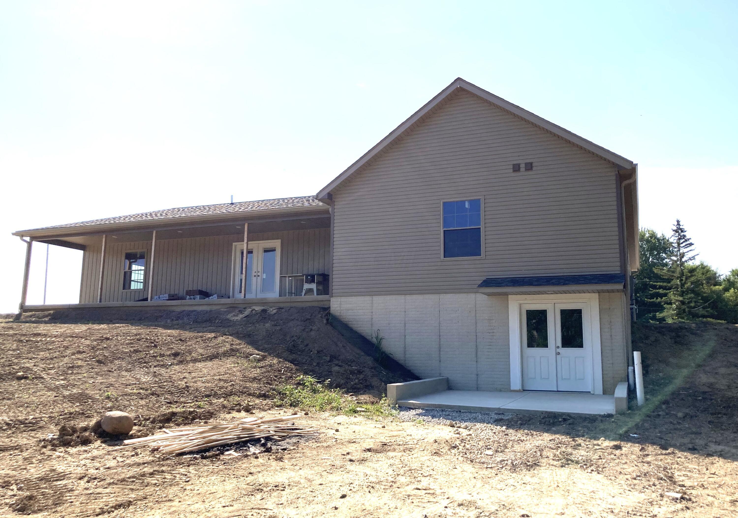 15571 Fairgrounds Road Centerburg, OH 43011 - Photo 5 of 6 Covered back porch and walkout patio.
