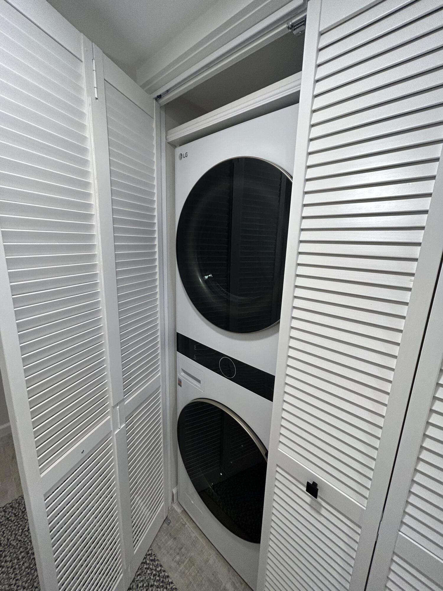 13334 Polo Club Road, Unit 203 Wellington, FL 33414 - Photo 13 of 19 a view of a hallway with washer and dryer