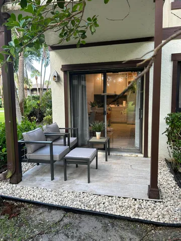 a view of a swimming pool with chairs in patio