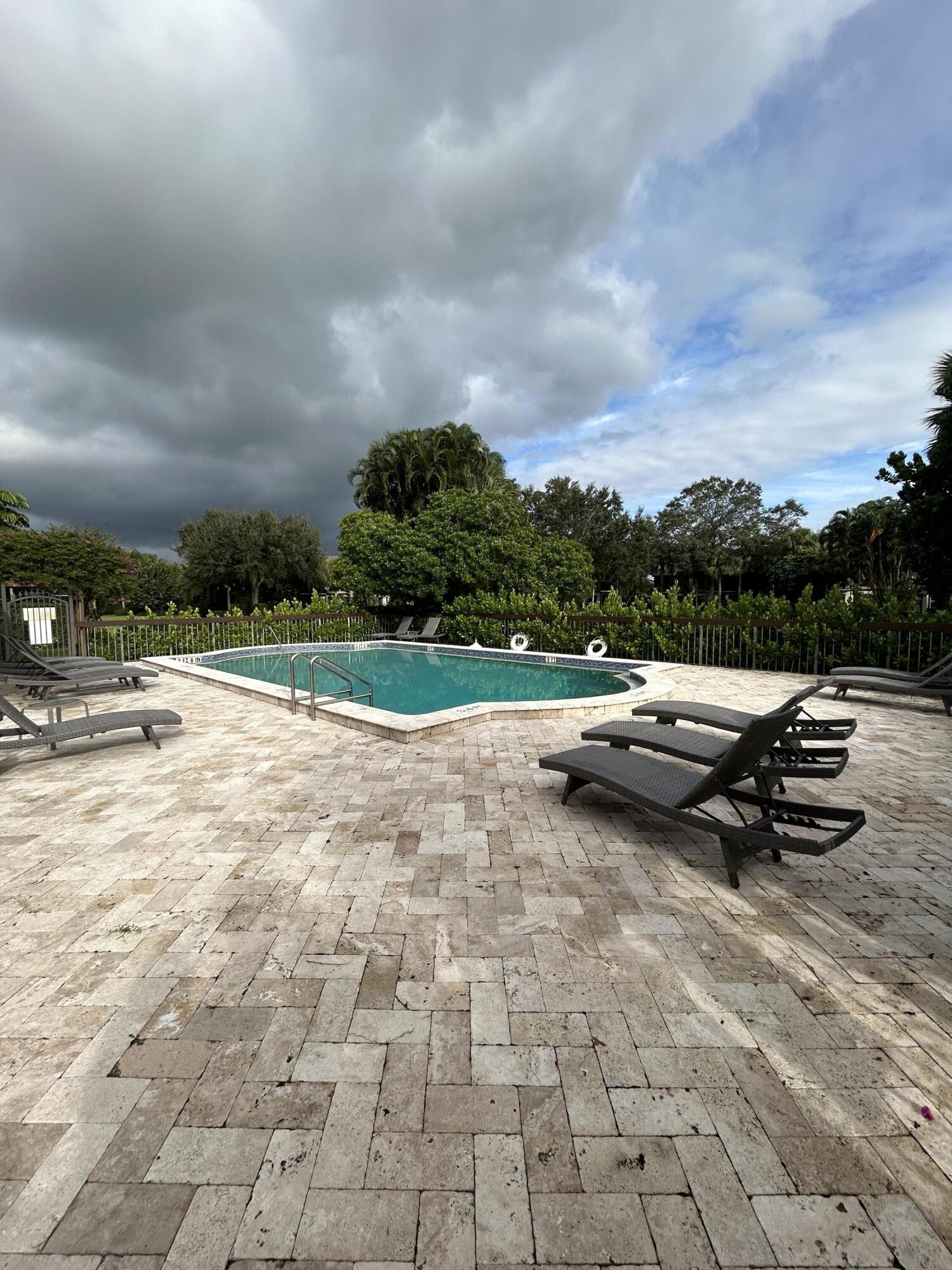 13334 Polo Club Road, Unit 203 Wellington, FL 33414 - Photo 17 of 19 a view of swimming pool with a yard