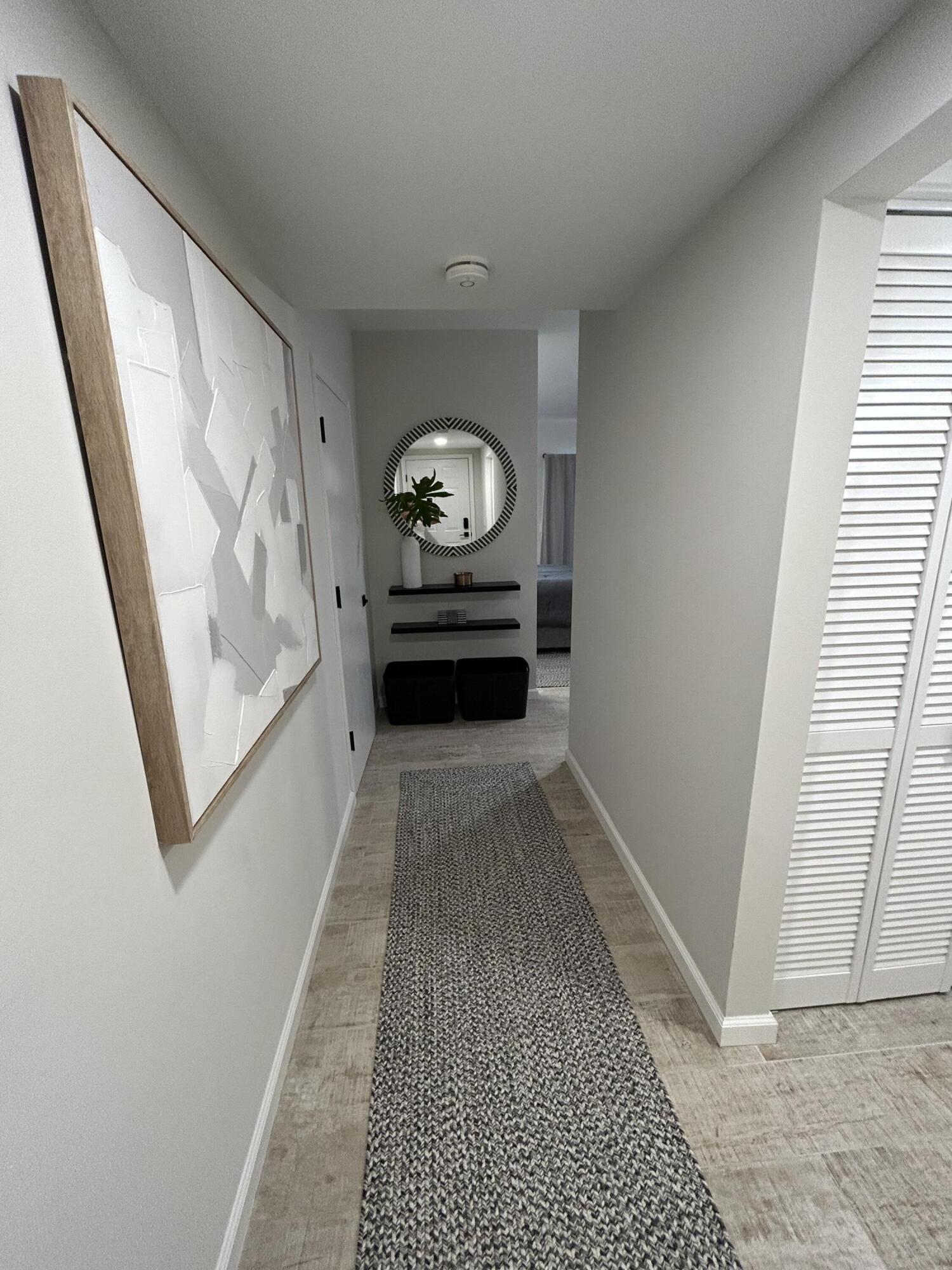 13334 Polo Club Road, Unit 203 Wellington, FL 33414 - Photo 2 of 19 a view of a hallway to a livingroom with furniture