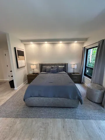 a bedroom with a bed window and couch